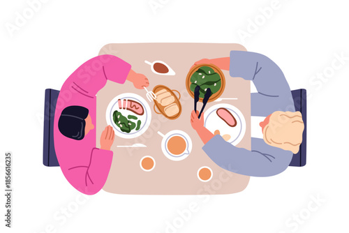 Couple sitting at dining table. Man and woman eating home food, dishes and sn...