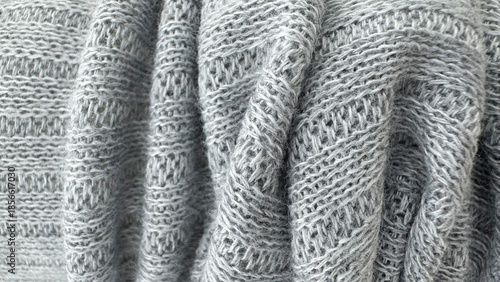 Soft gray knitted wool fabric texture background with detailed yarn pattern