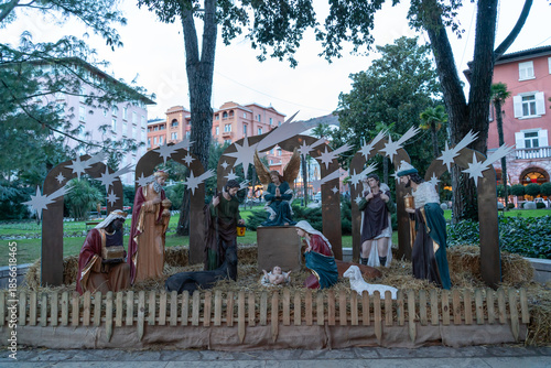 Traditional outdoor nativity scene with detailed figurines of the Holy Family and the Three Wise Men, displayed in a public park in Opatija, Croatia