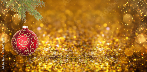 Vászonkép Christmas ball hanging from fir tree branch against festive background