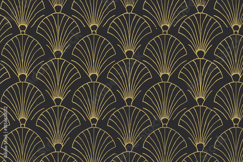 Decorative pattern with fan shapes in gold on black background displayed in a design studio setting during daytime