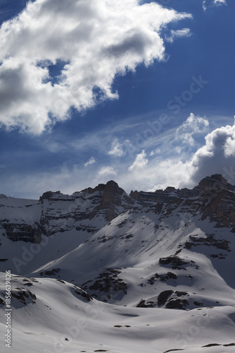 Snow mountains and blue sky with clouds