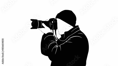 Silhouette of a photographer holding a camera and taking a picture.