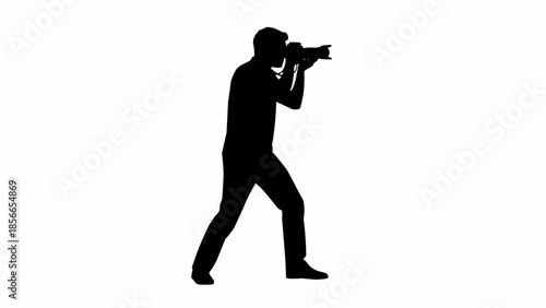 Silhouette of a photographer taking a picture with a professional camera.