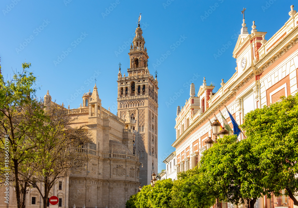 Fototapeta premium Giralda tower of Seville cathedral on Triumph square, Spain