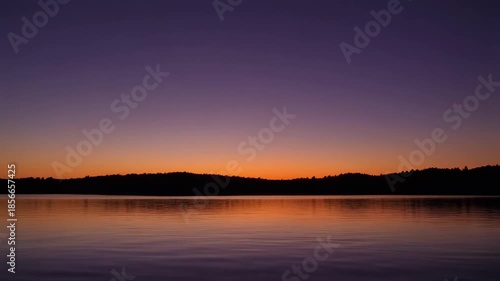Wallpaper Mural Tranquil lake reflecting colorful sunset sky over distant hills Torontodigital.ca