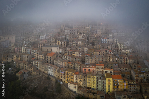 Sunrise view of the rooftops of Gangi with morning fog. Sicily, Italy. August 2024. Aerial drone picture.
