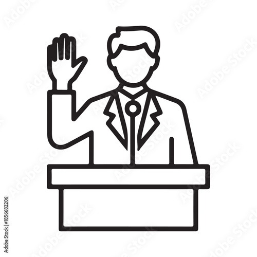 A man in a suit raising his hand while standing at a podium