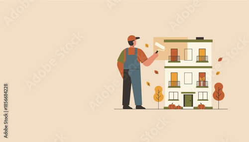 Painter applying fresh paint to building exterior during autumn renovation and maintenance work