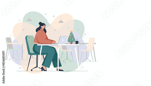 Woman working on laptop in a modern office with a Christmas tree decoration