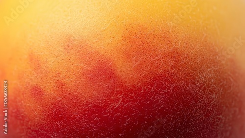 Close-up of a vibrant peach skin texture with a gradient of yellow, orange, and red hues.