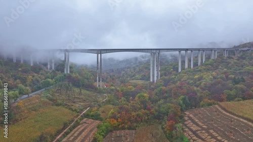 Aerial View of Viaduct over the Autumn Colorful Valley