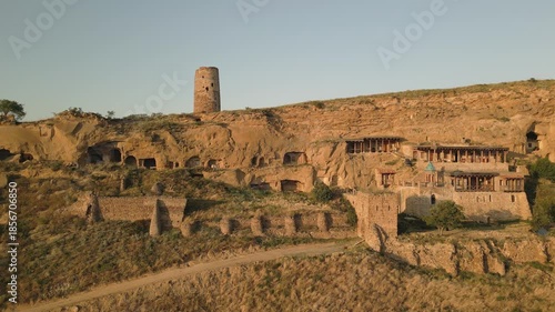 Aerial view Natlismtsemeli Monastery complex carved into cliffs, medieval Georgian Orthodox architecture in remote Kakheti hills. Part of David Gareja monastic complex. Azerbaijan Georgia border zone