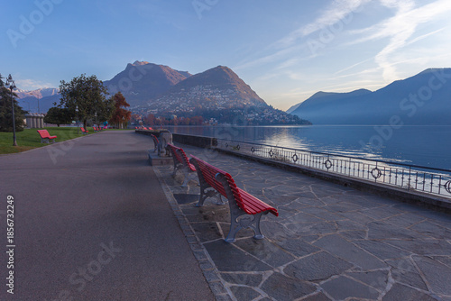 Panorama of the Lugano promenade facing the lake at dawn, without people. Lugano, Ticino, Switzerland
