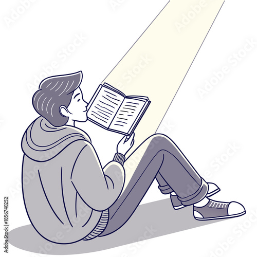 A young man is deeply engrossed in reading a book illuminated by a radiant beam of light above