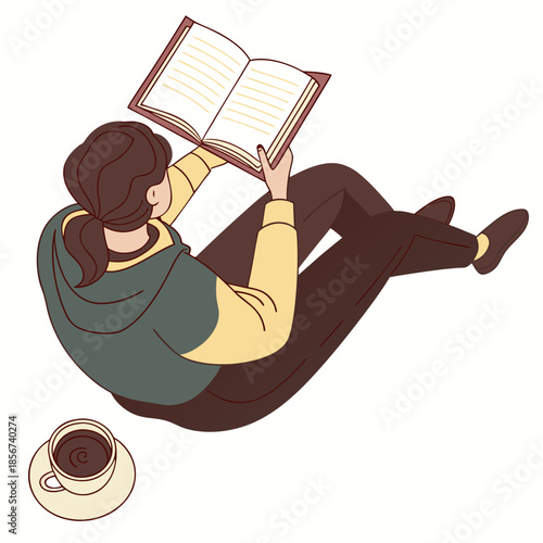 A woman leisurely reading a book while lying down with a cup of coffee nearby creating a cozy scene