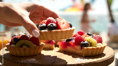 Delicious Fruit Tarts on a Wooden Board at a Beach Party.