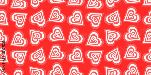 Seamless vector pattern with red and white striped hearts on red background. Ideal for Valentine’s Day textiles, wrapping paper, festive decor and romantic designs
