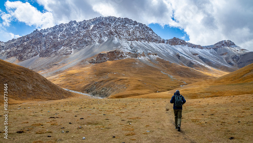 Tian Shan mountains glacier and snow summits on a sunny day with blue sky. Kyrgyzstan mountains on the border with China high altitude snow and glacier trek, climbing and alpinism in the wilderness