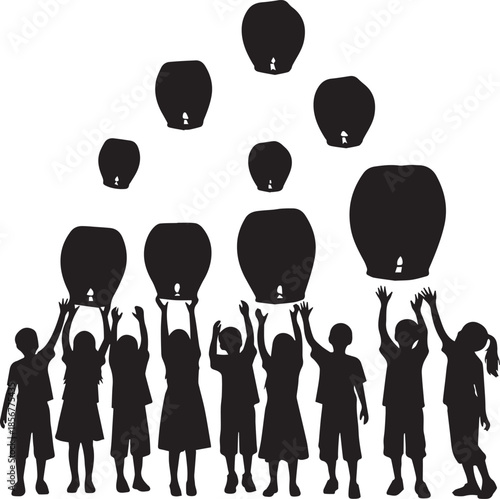 Children releasing sky lanterns into the night sky silhouette
