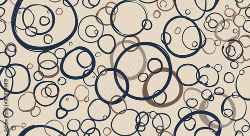 Painterly pattern of hand drawn overlapping circles in navy blue and cocoa brown on a soft beige background creates a rustic and artistic feel.
