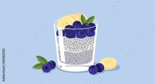 Healthy chia seed pudding in a glass layered with milk and topped with fresh blueberries, banana slices, and green mint leaves.