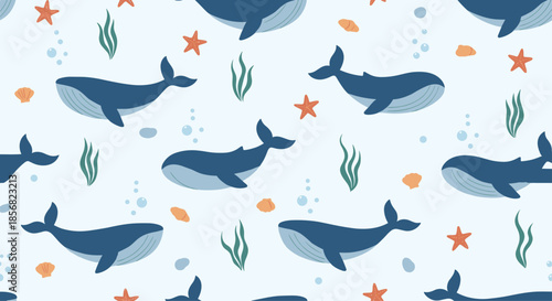 Large blue whales and sea life pattern including starfish and seaweed on a light blue background for nursery and ocean decor.