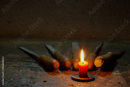 Files and tools on the workbench, with a flickering candle beside them creating a calm, handcrafted atmosphere in the warm glow of Christmas light.