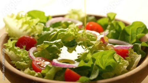 Salad: Fresh, vibrant salad brimming with fresh lettuce, juicy tomatoes, and crisp red onions. The bright colors and natural textures creates an appetite.