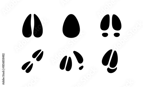 Collection of black animal footprints and hoof prints on a white background