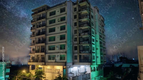 Nighttime Urban Apartment Building with Illuminated Balconies After Rain