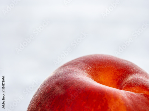 Close-up of a juicy ripe peach with white background.