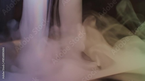Mysterious Vapor: A captivating display of swirling vapor, illuminated with soft, blended hues of light that dance and intertwine, creating an ethereal and abstract composition.