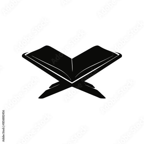 Open holy book, possibly the quran, presented on a traditional rehal for religious study