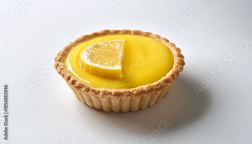 a small yellow lemon tart with a slice of lemon on top