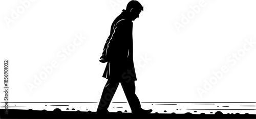 Silhouette of a contemplative man strolling along the shore in m

