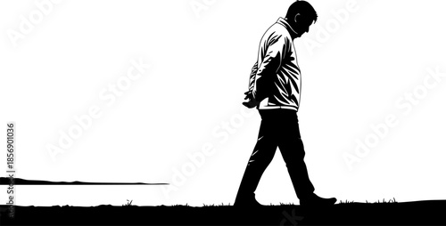 Silhouette of a contemplative man strolling along the shore in m

