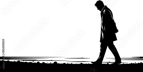 Silhouette of a contemplative man strolling along the shore in m
