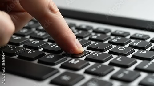 Typing on a Laptop Keyboard CloseUp of Finger Pressing Key.