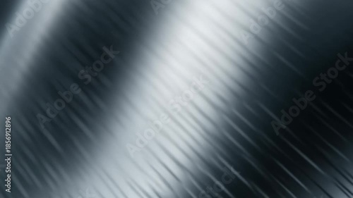 A reflective metal surface set against a solid black background, highlighting its shine and texture.