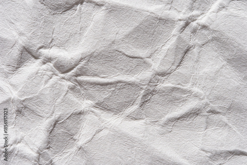 Tableau sur toile Close-up of crumpled white paper texture with wrinkles and creases for background or design use