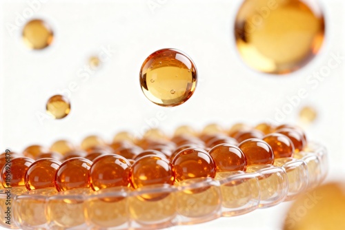 Glossy amber serum capsules arranged in a circular pattern with one floating droplet above on a bright background. Abstract 3D visualization for vitamins, cosmetics, collagen and skincare concepts.