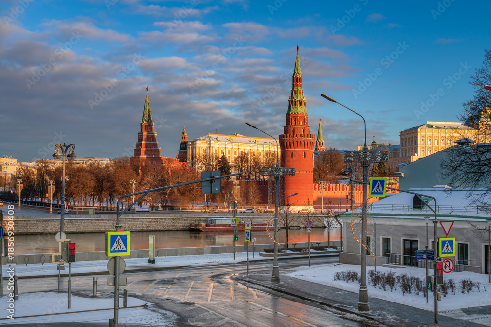 Fototapeta premium Kremlevskaya embankment and the towers of the Moscow Kremlin from the and Sofiyskaya embankment of the Moskva River on a sunny winter day, Moscow, Russia