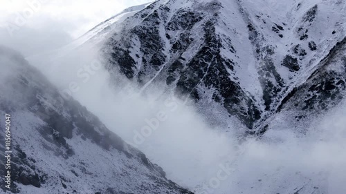 Fog Rolling Through Winter Mountain Basin Drone View