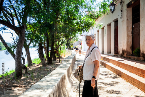 Wallpaper Mural Senior travel concept. Senior woman walking at the beautiful streets of the colonial Heritage Town of Santa Cruz de Mompox in Colombia. Torontodigital.ca