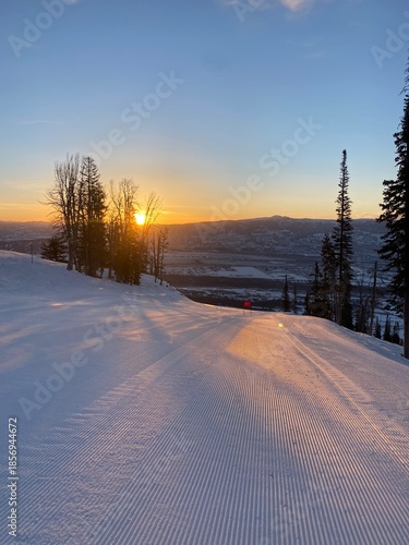 Sun rise over a ski run at a ski resort