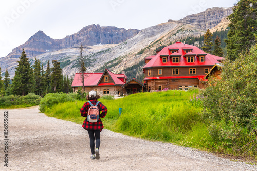 Tourist walking towards num ti jah lodge at bow lake in banff national park