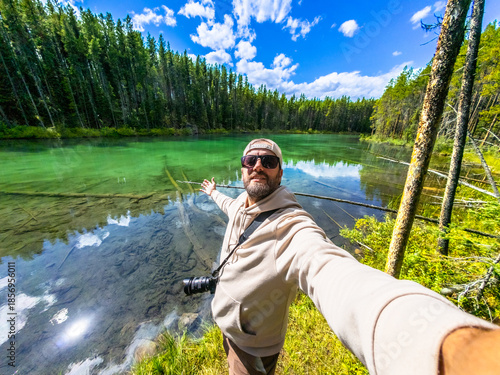 Photographer taking selfie at herbert lake in banff national park