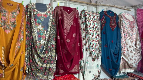traditional indian kurtis hanging on clothing rack in local shop