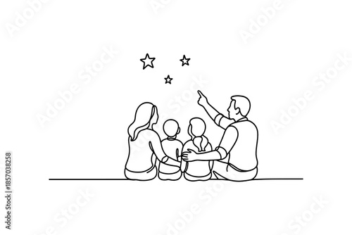 Family of four sitting together looking at stars in the night sky